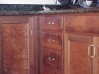 Beautiful burl and curly kitchen cabinets.