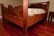 Custom-made redwood burl bed. Cats paw on lower-ends and sides. Posts are quarter sawn clear all heart vertical grain. Main foot and head boards are lacy burl.