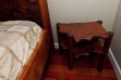 Custom-made redwood burl night table, beside custom redwood bed.