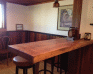 Redwood Bar with rainbow wainscoting, half panels, in background.